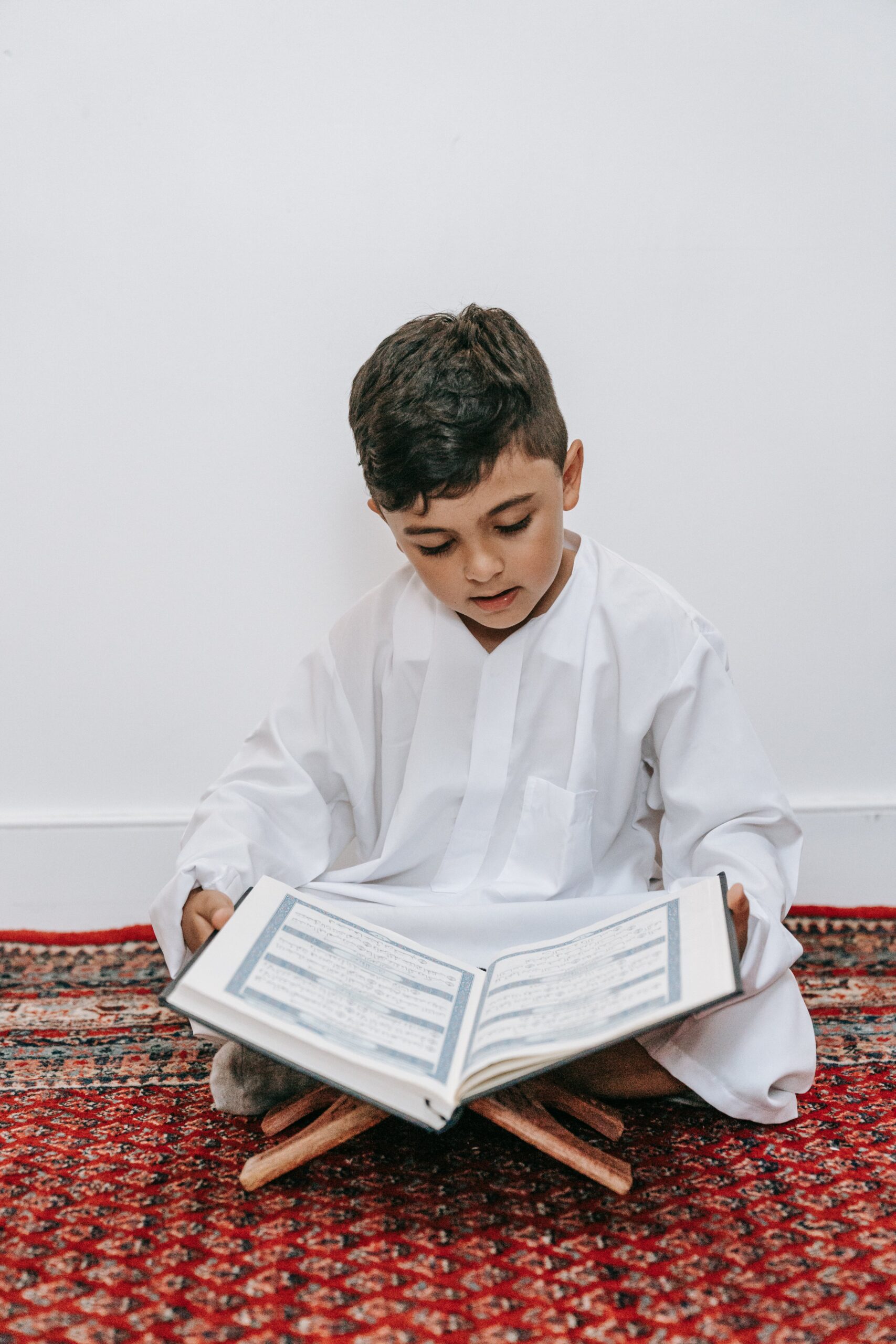 A student engaged in Quran Memorization in the USA, reciting and learning with expert guidance.